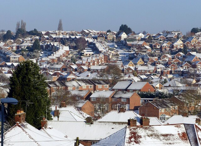 Snow-covered roofs in Carlton, Nottinghamshire, illustrating roof heat retention, not an Eastern Roofing installation