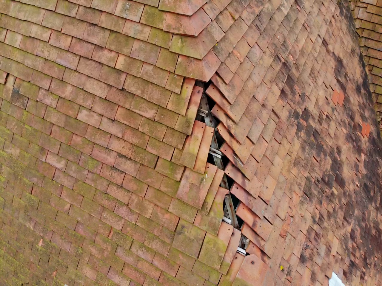 Drone inspection close-up of damaged roof tiles